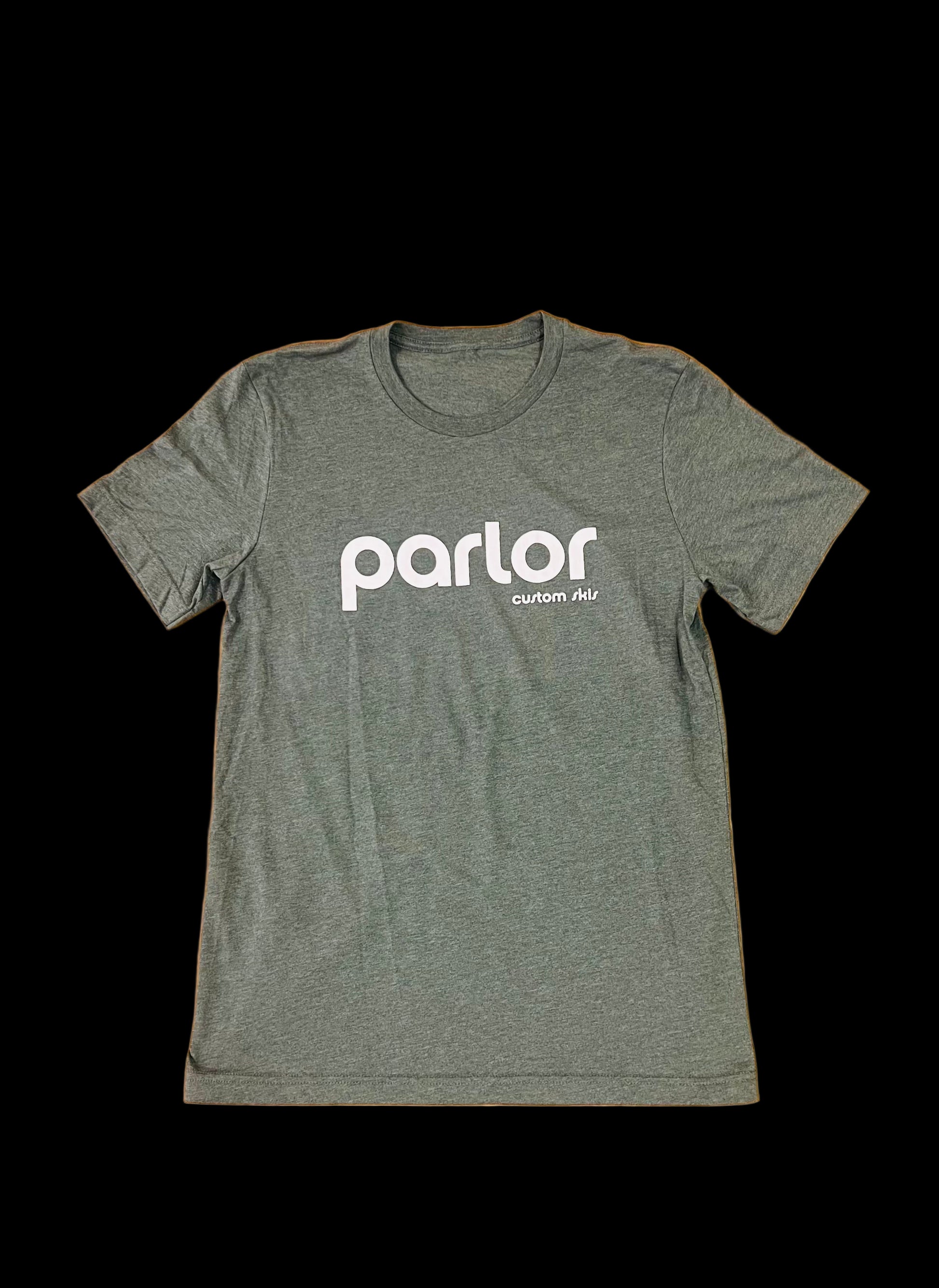 A green t-shirt with the 'PARLOR' brand logo printed in white on the front and back, placed on a wooden surface.